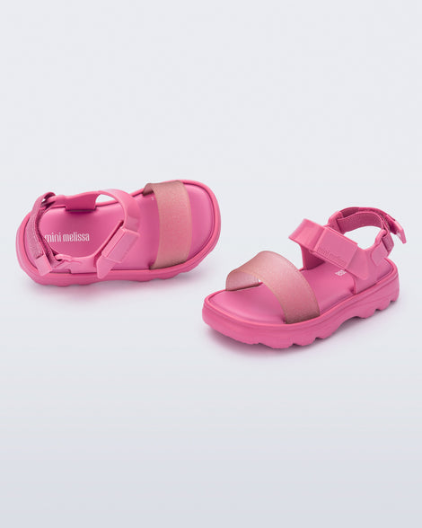 Angled view of a pair of pink baby Kick Off Sandals