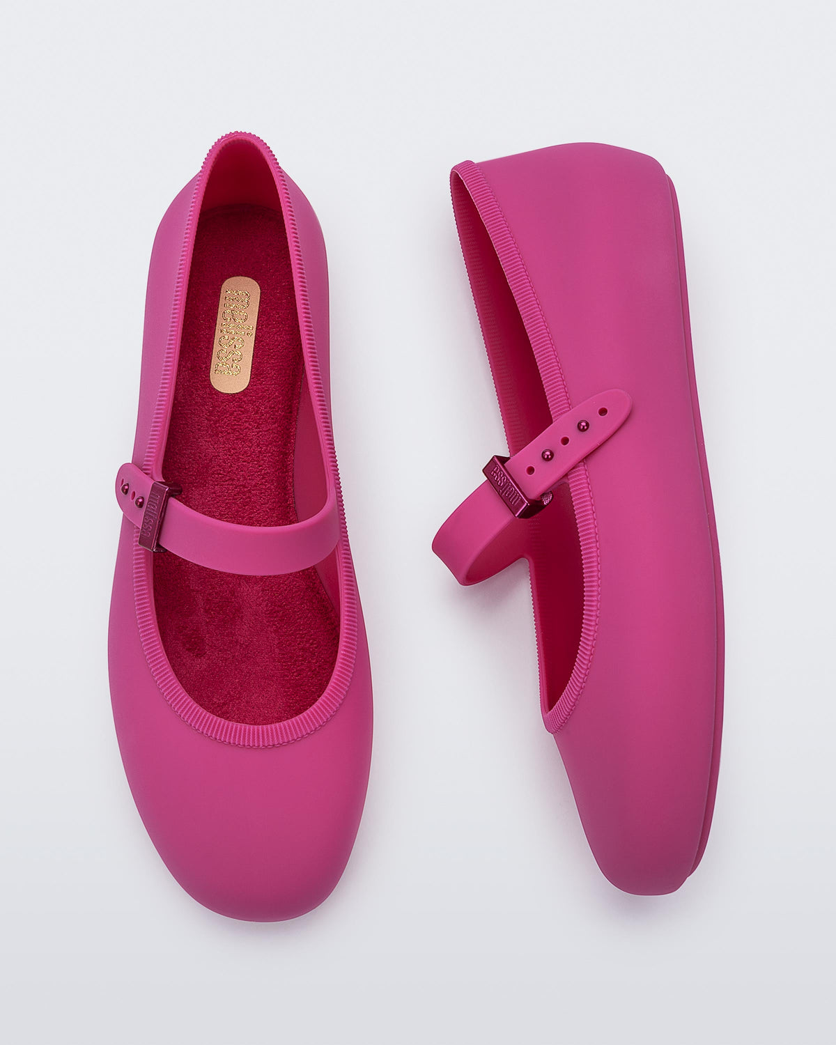 Top and side view of a pair of pink Soft adult flats with strap and pink buckle