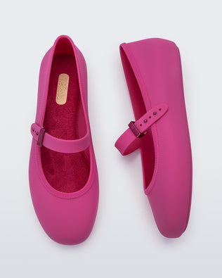 Top and side view of a pair of pink Soft adult flats with strap and pink buckle