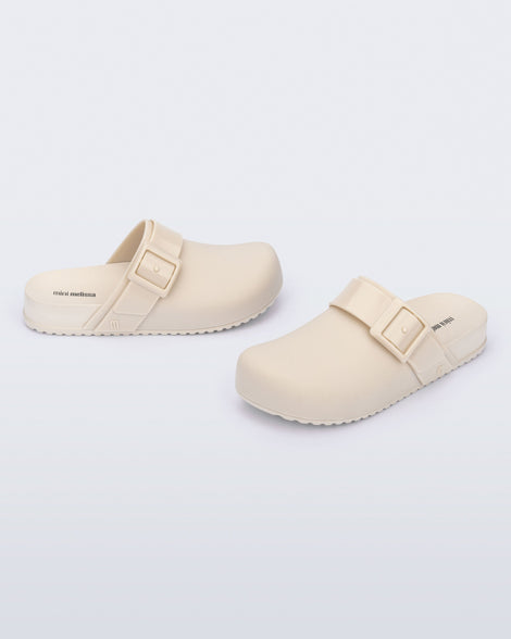 Angled view of a pair of beige kids Cozy Clogs