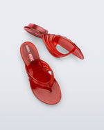Top and side view of a pair of transparent red Flip Flop + Diesel sandals