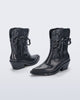 Front and back angled view pf a pair of metallic grey Texas + Maldito boots