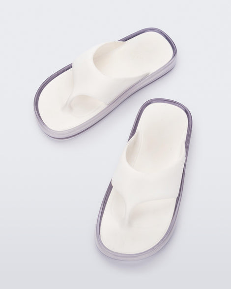 Top view of a pair of white with clear sole Float flip flops
