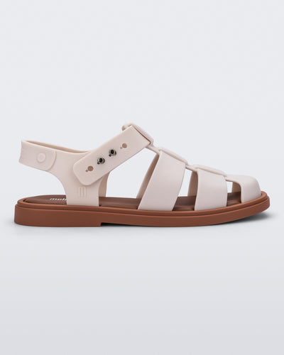 Side view of a beige Emma women's sandal with brown sole.