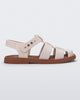 Side view of a beige Emma women's sandal with brown sole.
