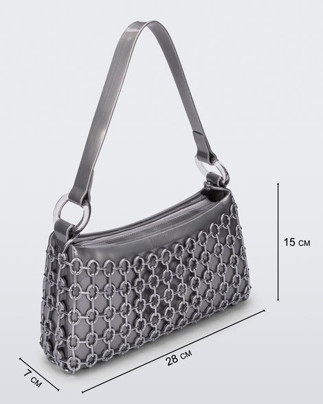 Angled view of a silver Hoop bag with short shoulder strap with bag dimensions: 28 cm x 7 cm x 15 cm