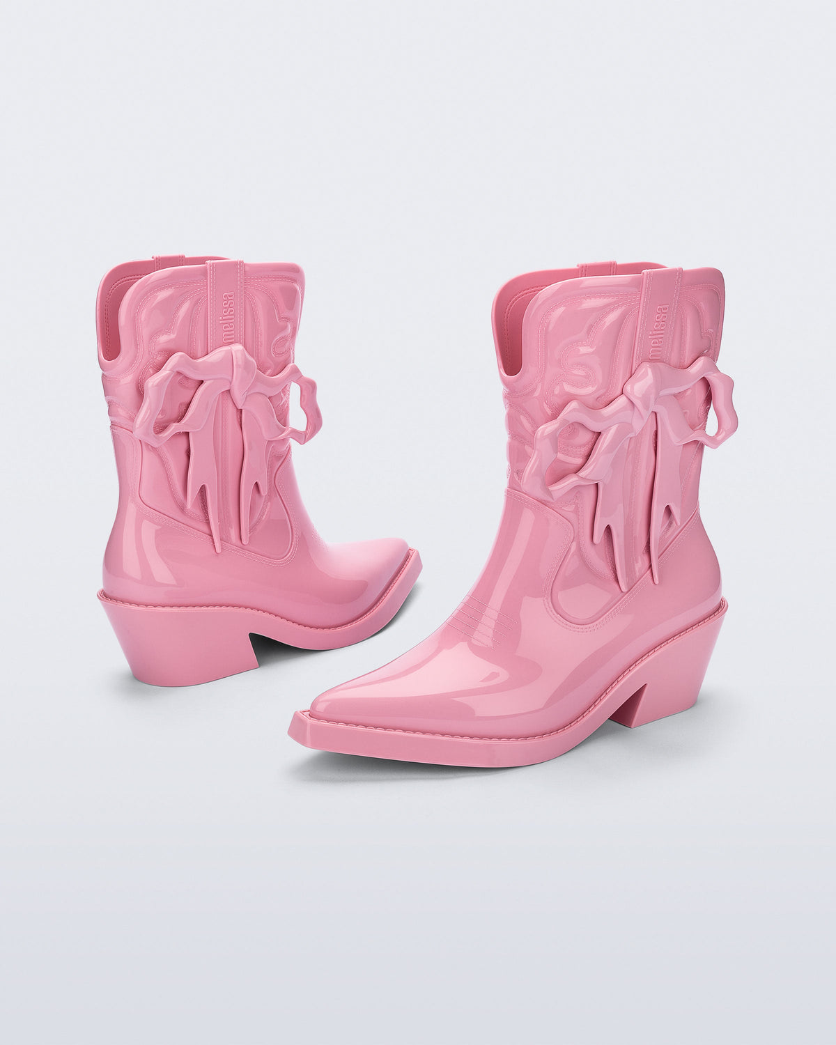 Front and back angled view pf a pair of pink Texas + Maldito boots