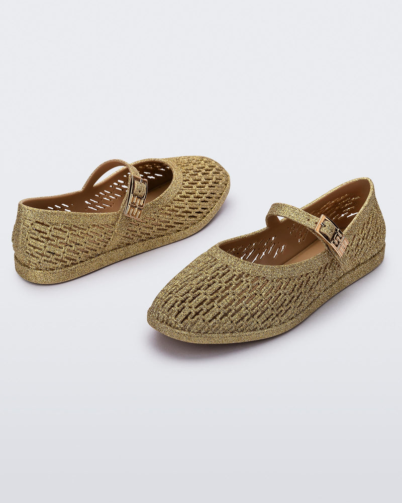Top and angled view of a pair of beige glitter Harper flat with strap