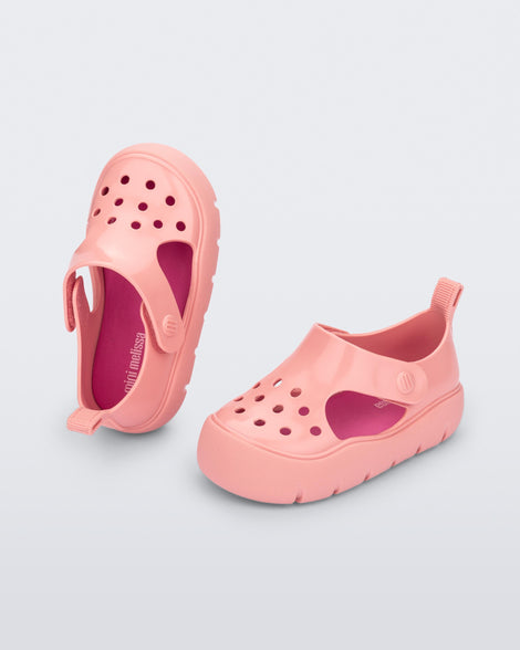 Top and angled view of a pair of pink Bowie baby sandals.