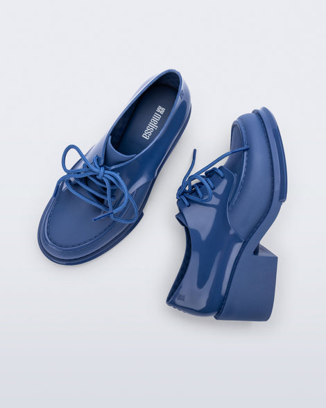 Side and top view of a pair of blue Tailor loafers