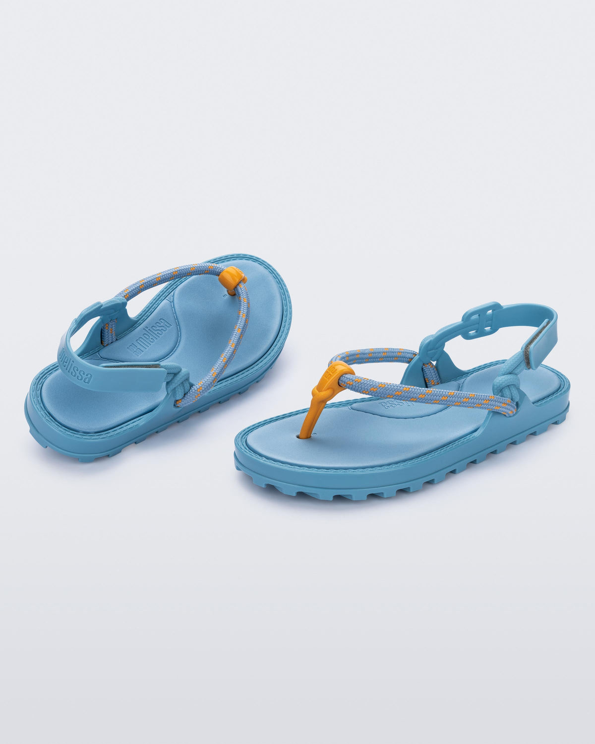 Angled view of a pair of blue Bond sandals with textile strap and orange toe piece