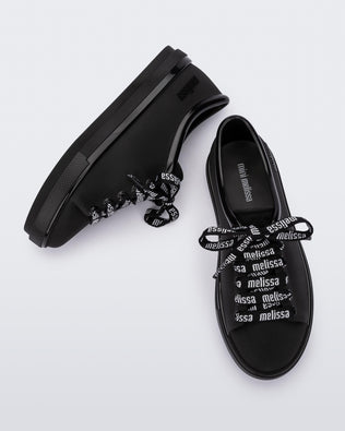 Top and side view of a pair of black Hip M Lover kids sneakers with laces.