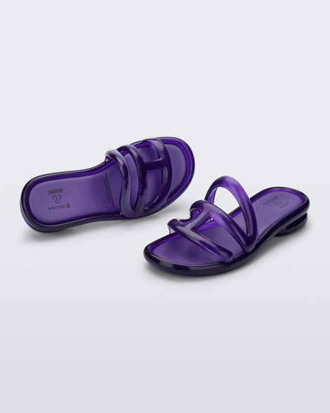 Angled view of a pair of purple Jelly Slide x Telfar.