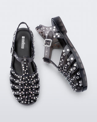 Top and side view of a pair of clear black Possession Crystals sandals