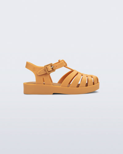 Side view of a matte caramel Possession baby fisherman sandal.