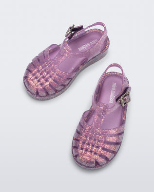 Top and side view of a pair of glitter lilac baby Possession sandals