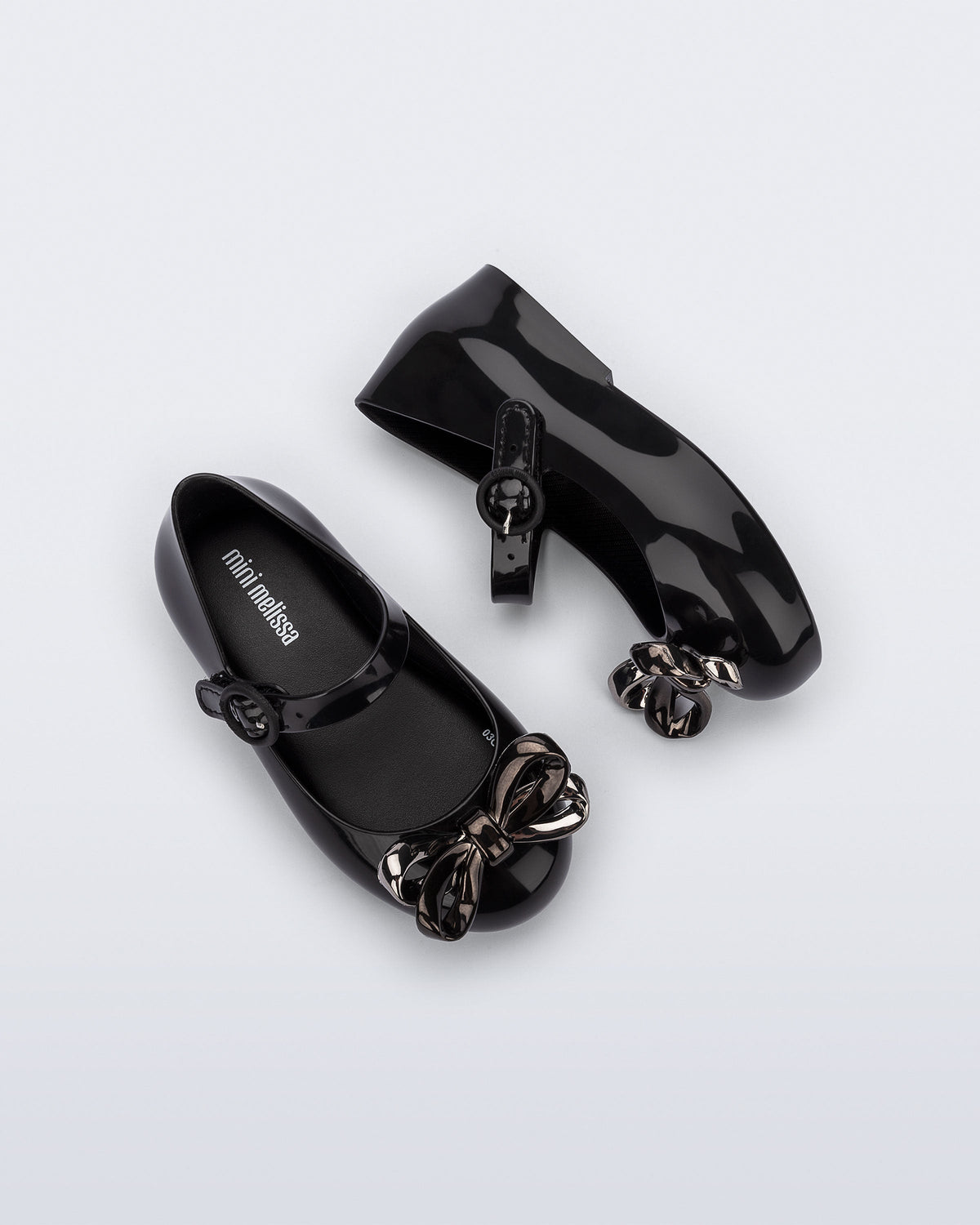 Top and side view of a pair of black Sweet Love Glam baby ballerinas with bow