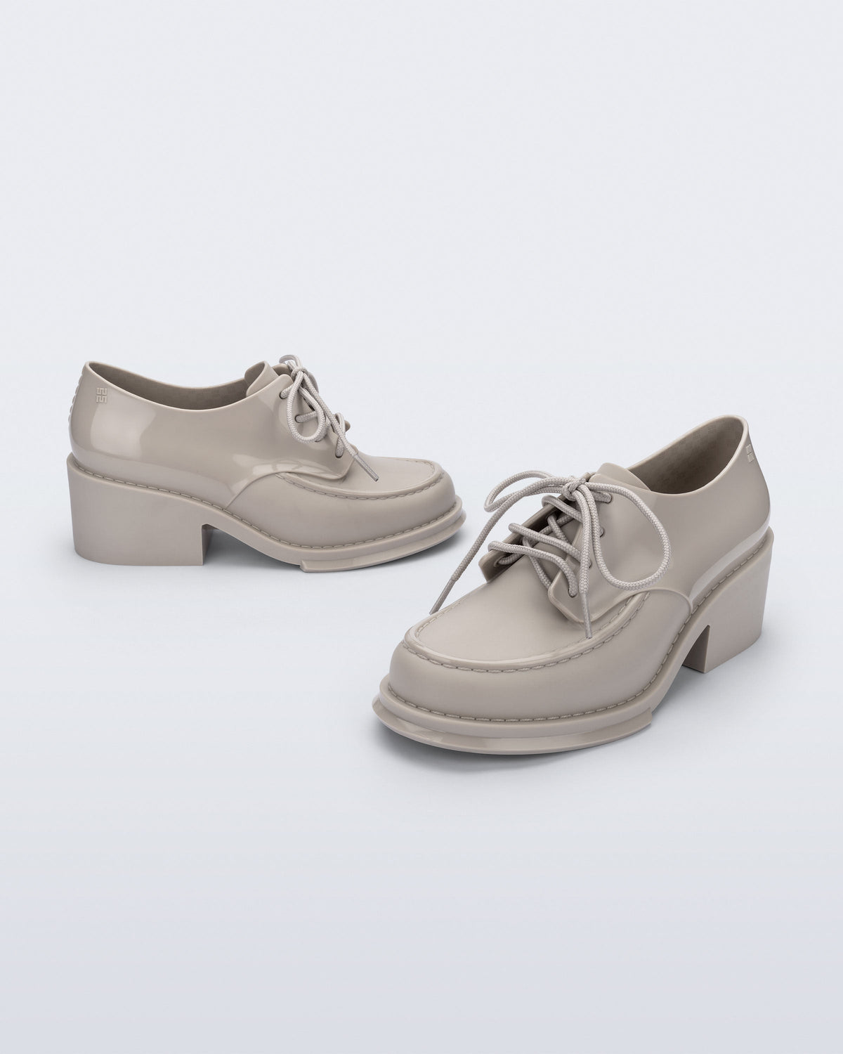Side and angled view of a pair of beige Tailor loafers