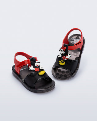 Angled view of a pair of black  Play Mickey & Minnie sandals with red straps