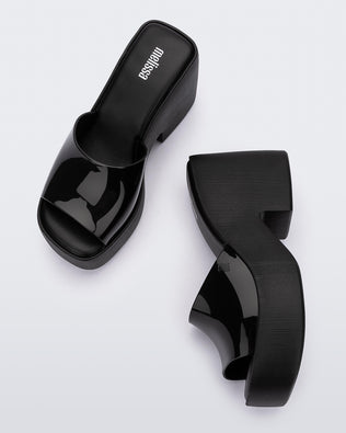 Top view and side view of a pair of Melissa Posh platform slides in Black