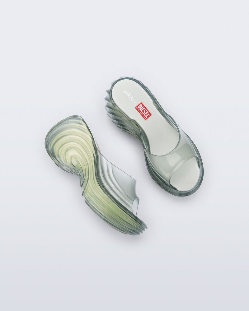 Top and side view of a pair of transparent green Platforms + Diesel slides