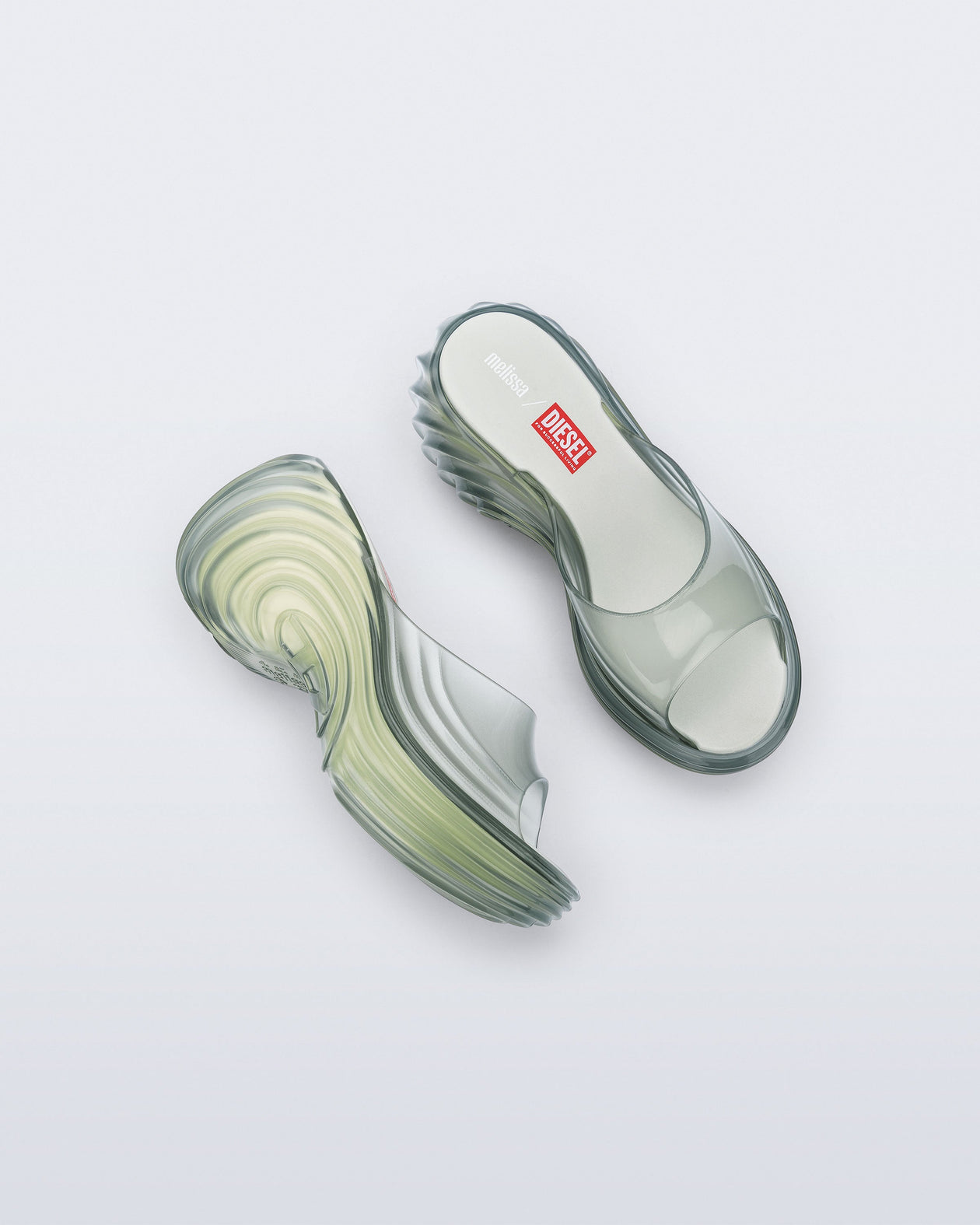 Top and side view of a pair of transparent green Platforms + Diesel slides