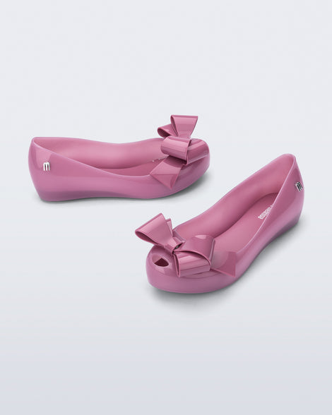 Top and side angled view of a pair of lilac Ultragirl Classy baby ballerina flats with lilac bow