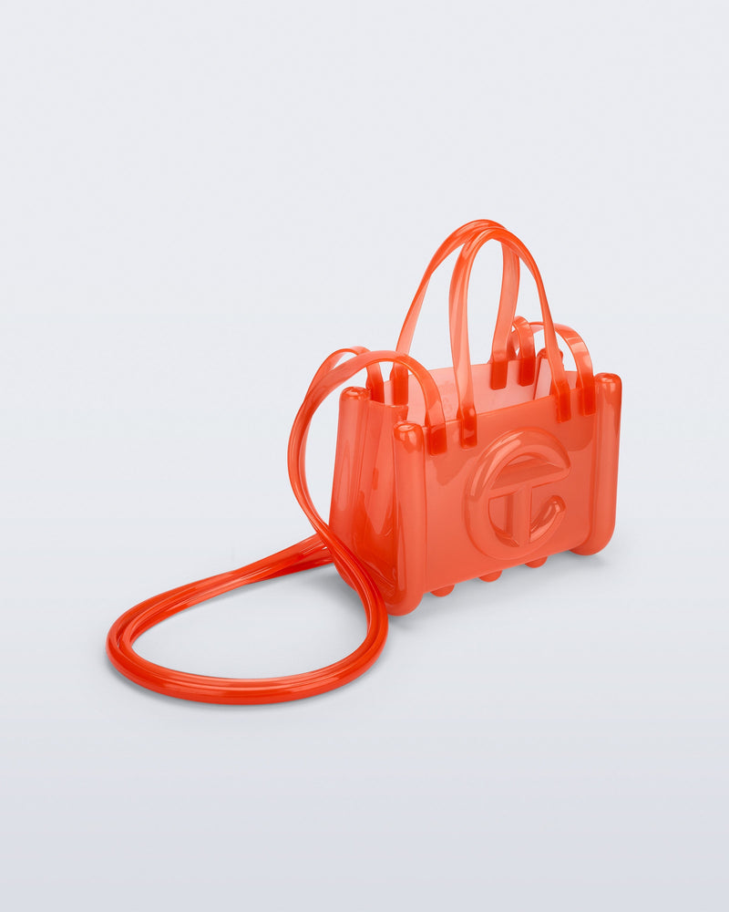 Angled view of the orange Small Jelly Shopper x Telfar bag