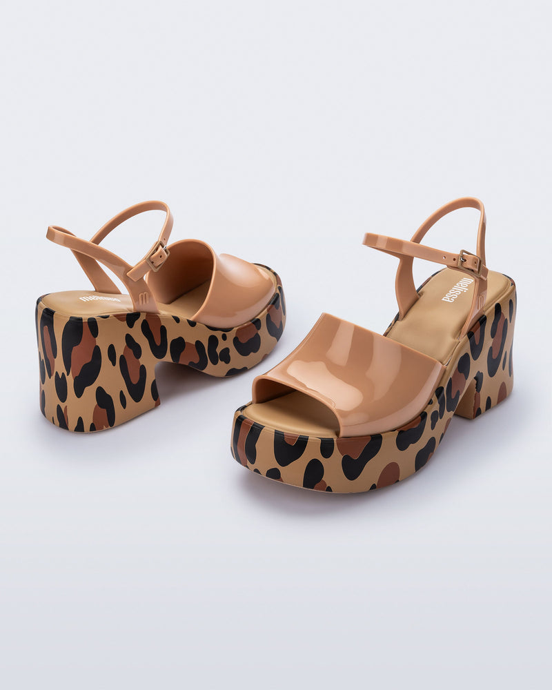 Angled view of a pair of brown with animal print sole Lina platform heels