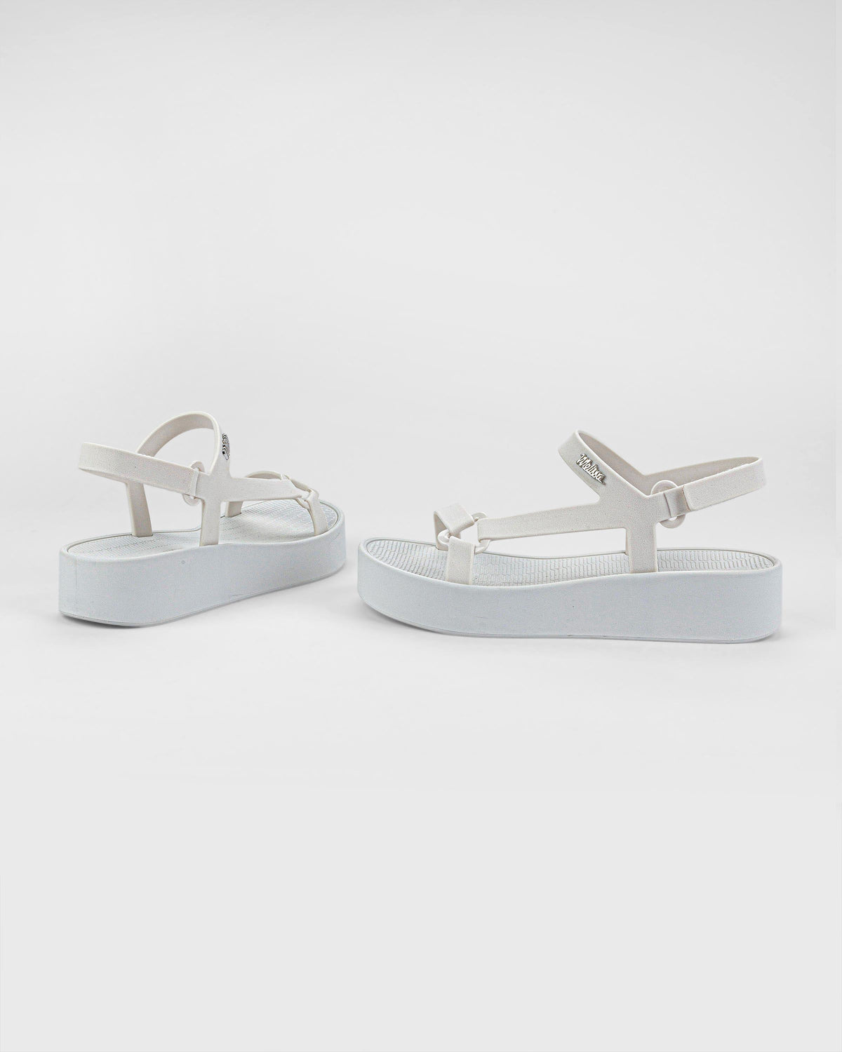 Angled side and back view of a pair of white Sun Downtown Platform sandals