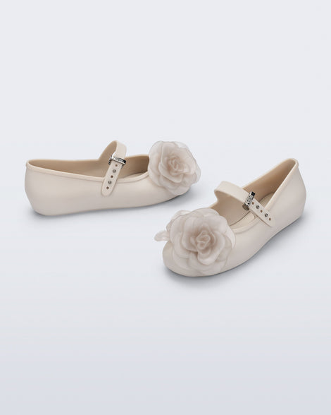 Side and angled view of a pair of beige Soft Ballerina Petals kids flats