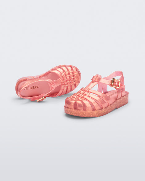 Top and angled view of a pair of pearly pink Possession sandals