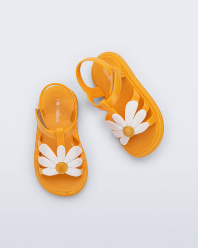 Top view of a pair of orange Hip Bloom baby sandals