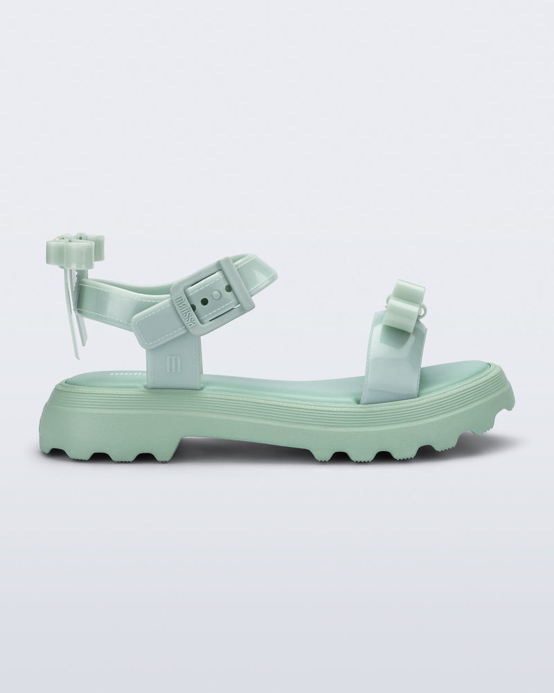 Side view of a green Town Bow sandal