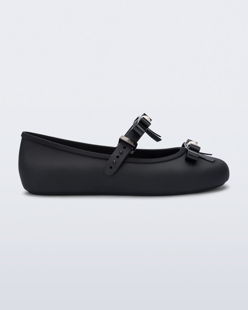 Side view of a black Soft Ballerina Bow with bows and a pearl in the center of each bow