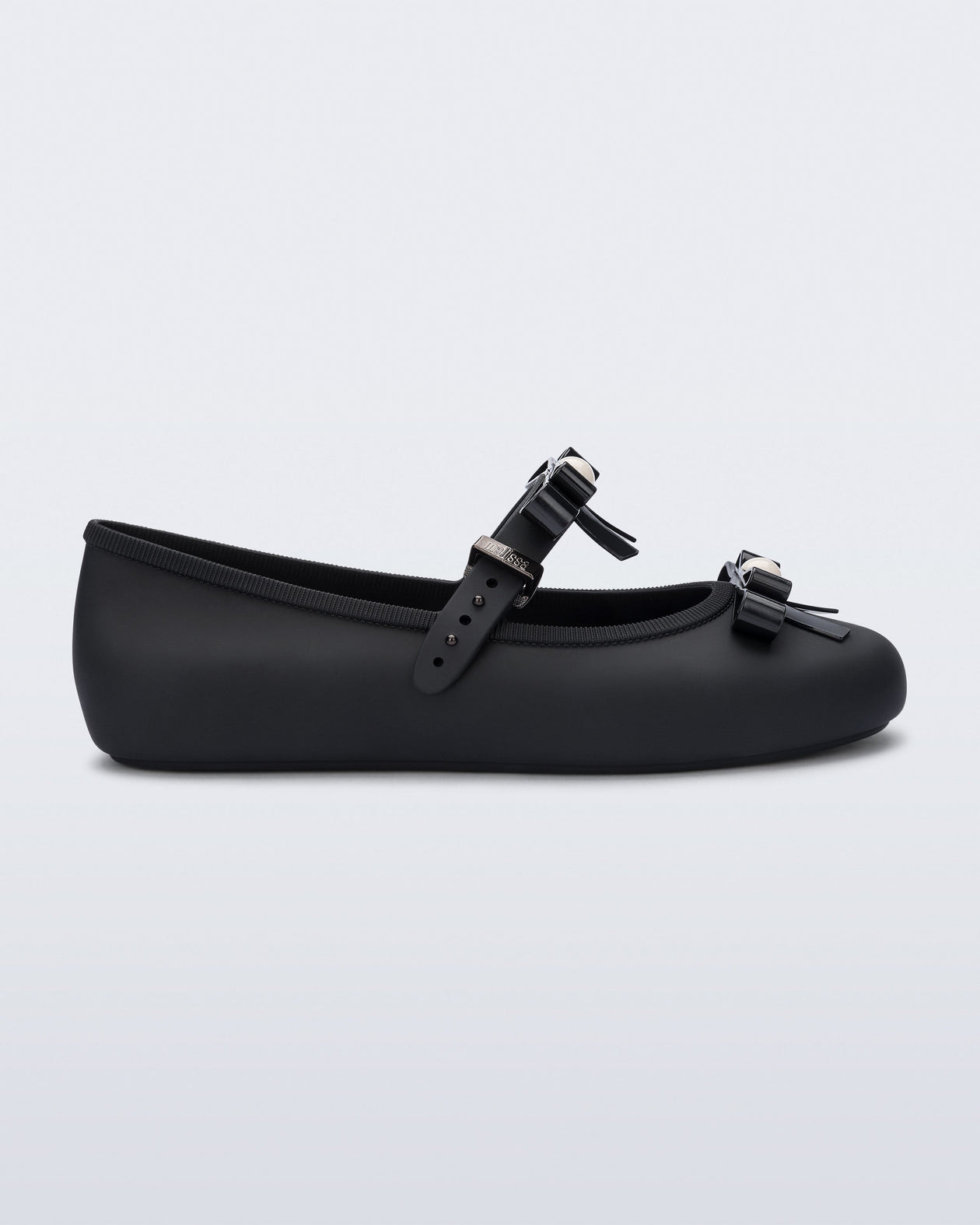 Side view of a black Soft Ballerina Bow with bows and a pearl in the center of each bow