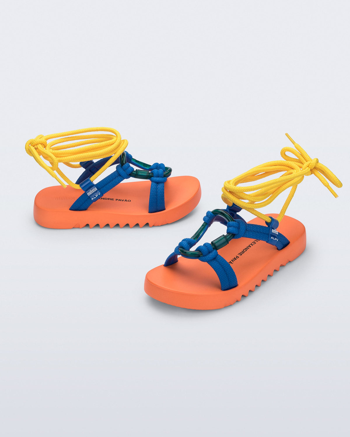 Side and angled view of a pair of orange sole, blue upper, and yellow ankle strap Kirk + Alexandre Pavao sandals