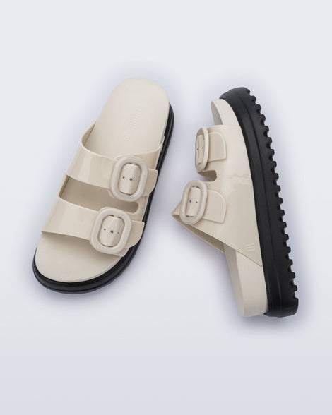 Top and side view of a pair of beige Cozy Platform slides