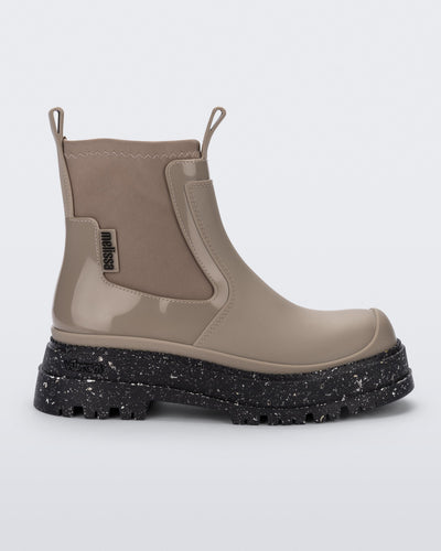 Side view of a beige Drip Boot with black sole