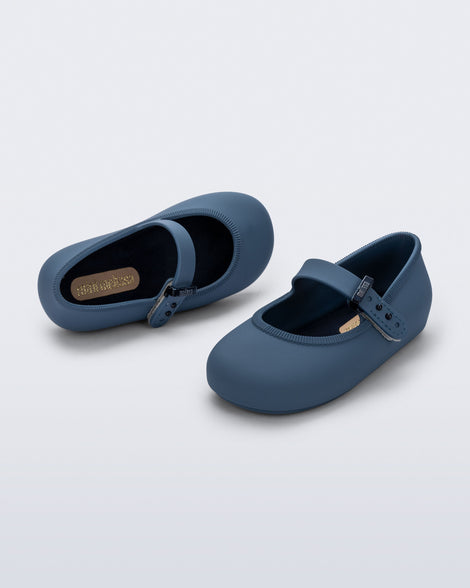 Top and side angled view of a pair of blue Soft Ballerina baby flat with Velcro strap