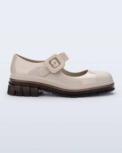 Side view of a beige with brown sole June mary jane with matte toe cap