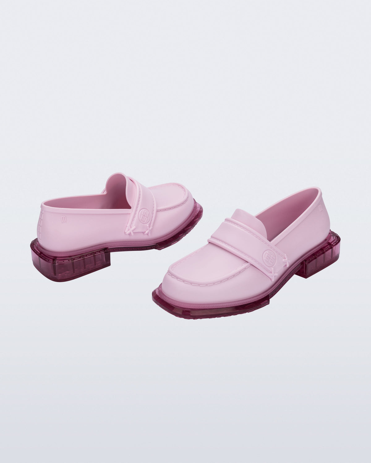 Back and angled view of a pair of pink Spencer loafers with clear pink soles