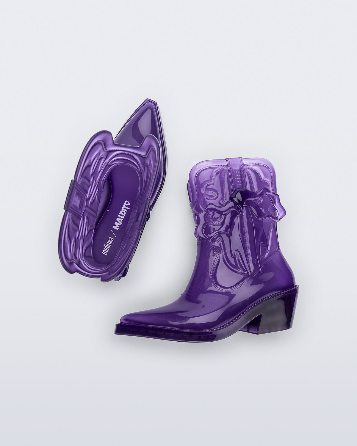Top and side view of a pair of transparent purple Texas + Maldito boots