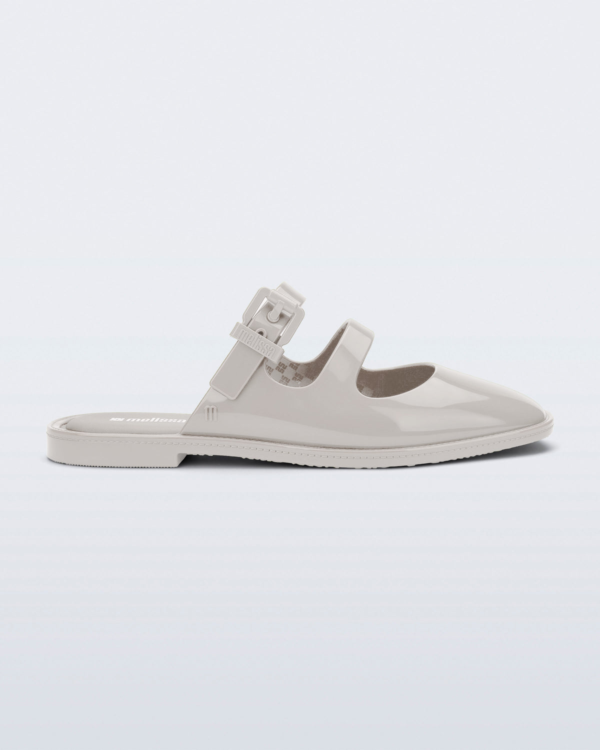 Side view of a beige Anastasia mule slide with upper straps