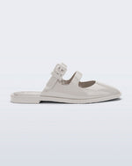 Side view of a beige Anastasia mule slide with upper straps