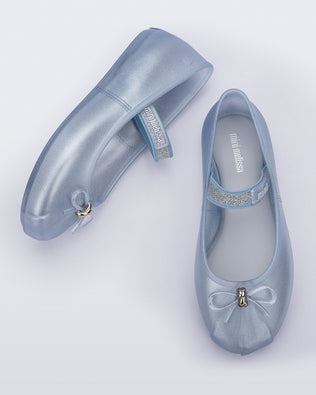 Side and top view of a pair of pearly blue Sophie kids ballerina flats with bow