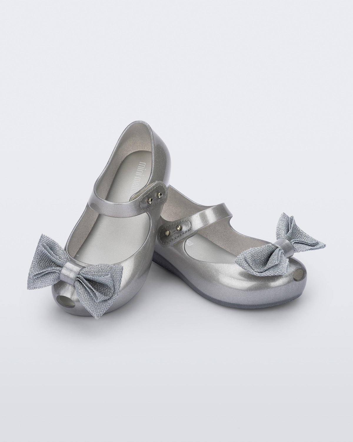 Angled view of a pair of pearly silver Ultragirl Sweet baby ballerina flats