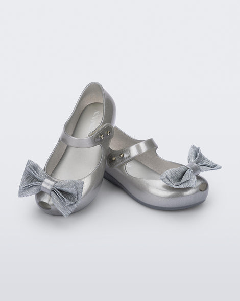 Angled view of a pair of pearly silver Ultragirl Sweet baby ballerina flats