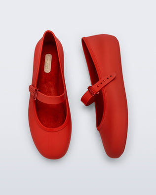 Side and top view of a pair of red Soft Ballerina flats with top buckle strap