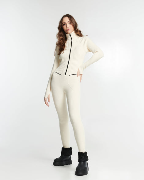 Model in a cream outfit wearing a pair of black Warm Boots with fuzzy cuff and insole